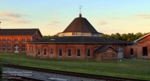 The setting sun casts a ruddy light on the B&O Roundhouse at Martinsburg, West Virginia.