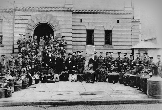 Prohibition in West Virginia State Police officers father around a collection of confiscated stills at the old Mingo County courthouse.