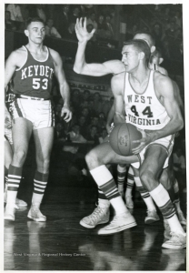 Basketball in West Virginia — Another high school-era snapshot: Jerry West in mid-air during a game, highlighting his signature athleticism even as a young player in East Bank.